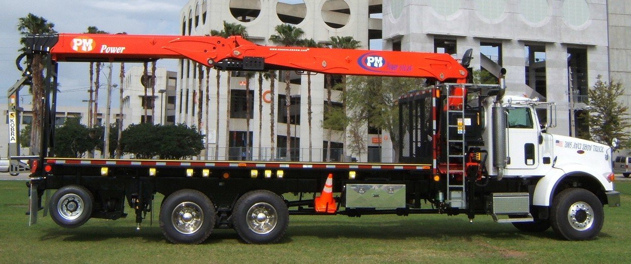 PM 610.24 drywall crane truck with the boom folded over the bed